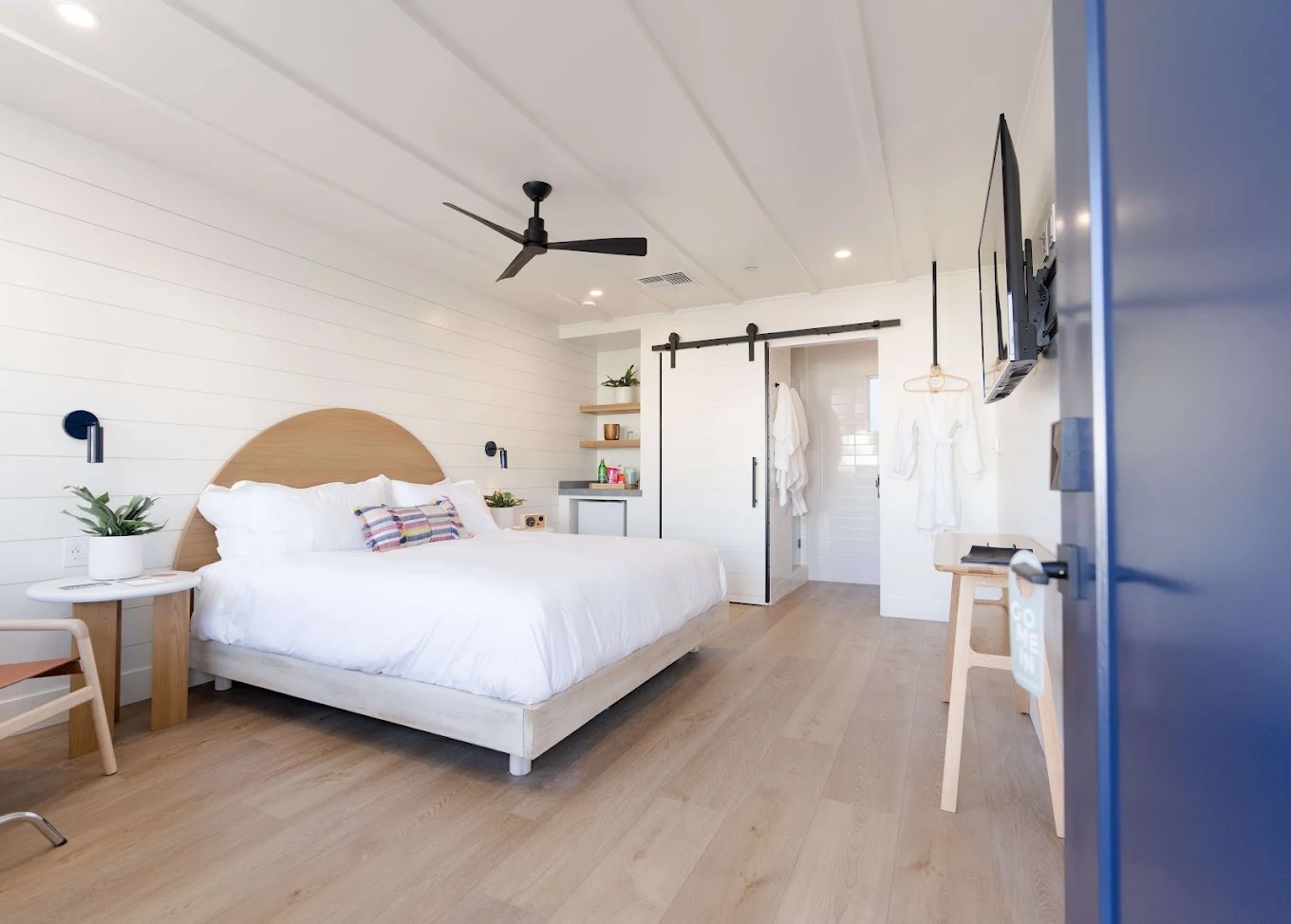 Guest room with arched wood headboard, The Pacific Motel