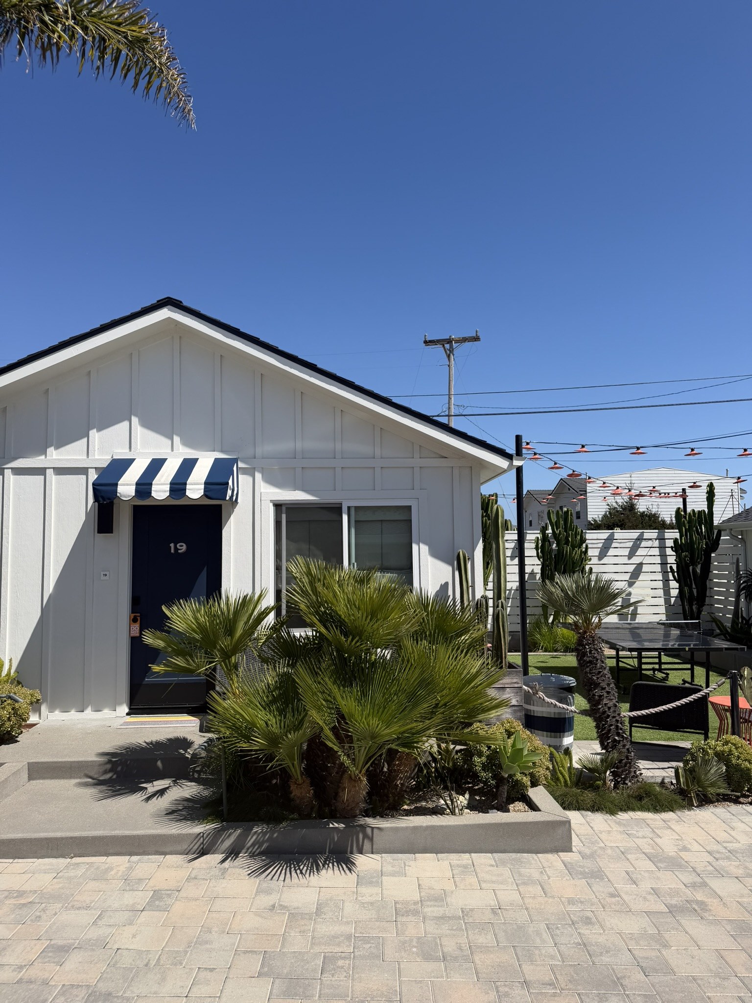 Cottage porch with ping pong table, The Pacific Motel